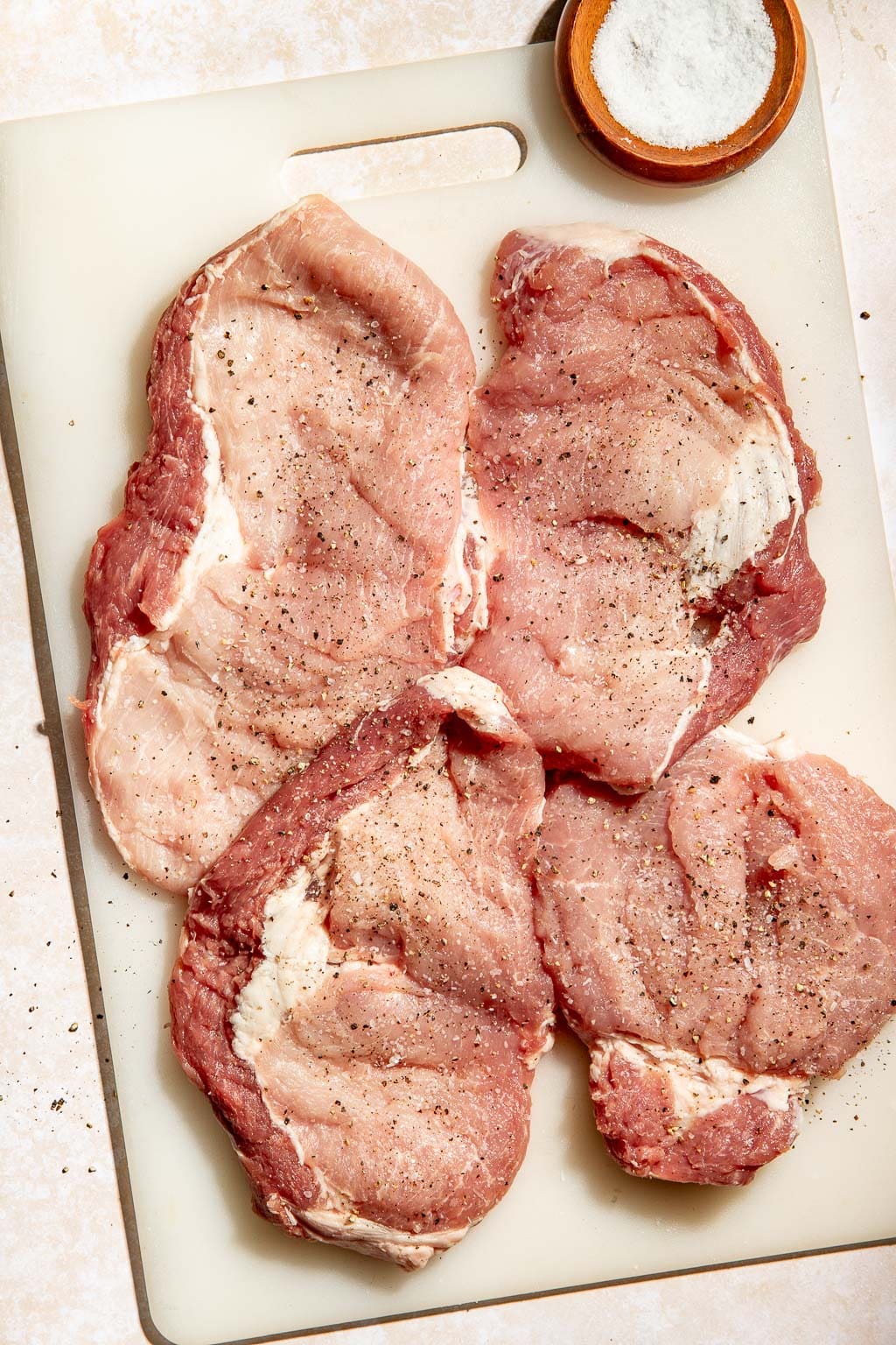butterflied pork pieces on a cutting board