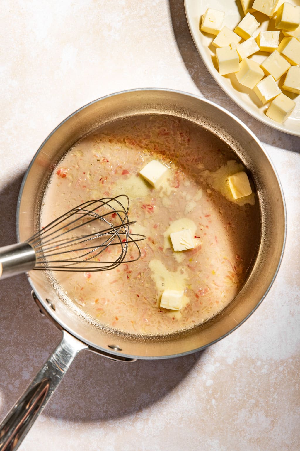 Butter being whisked into the sauce