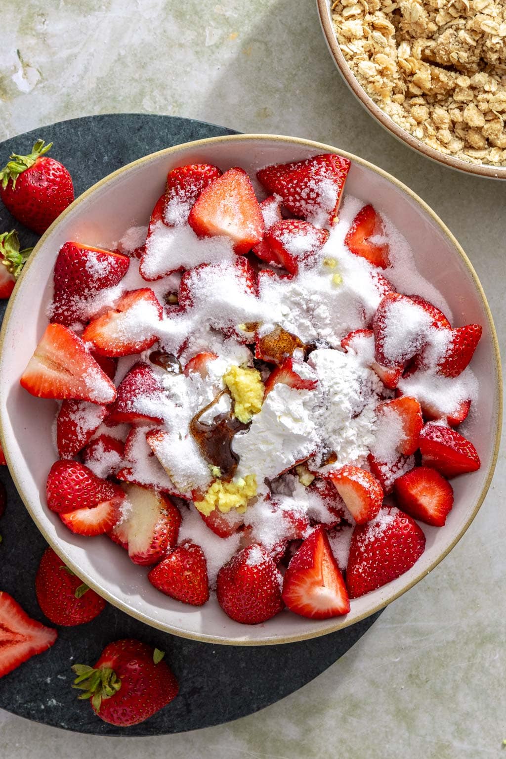 Strawberries with sugar, ginger, and cornstarch before mixing.