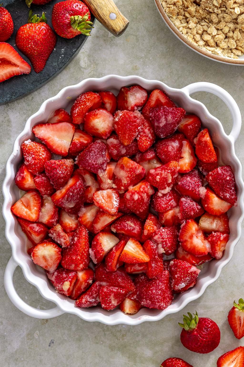 Sugared strawberries in a baking dish before being topped with the crisp topping.