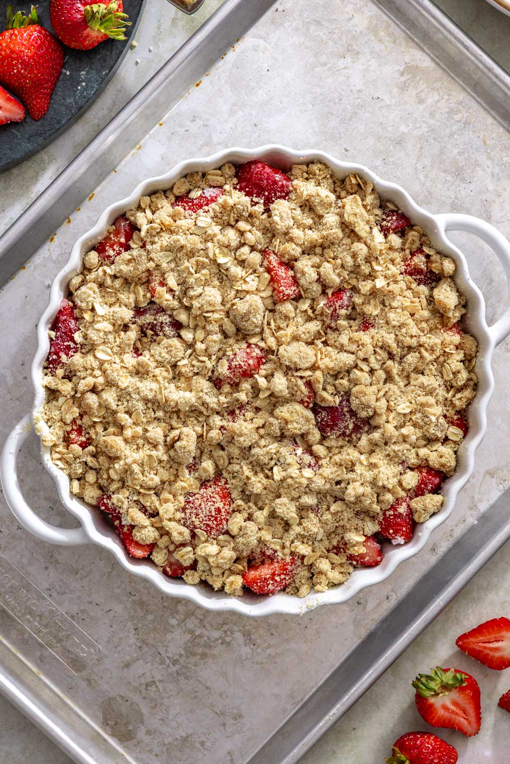Strawberry crisp on a baking sheet before going into the oven.