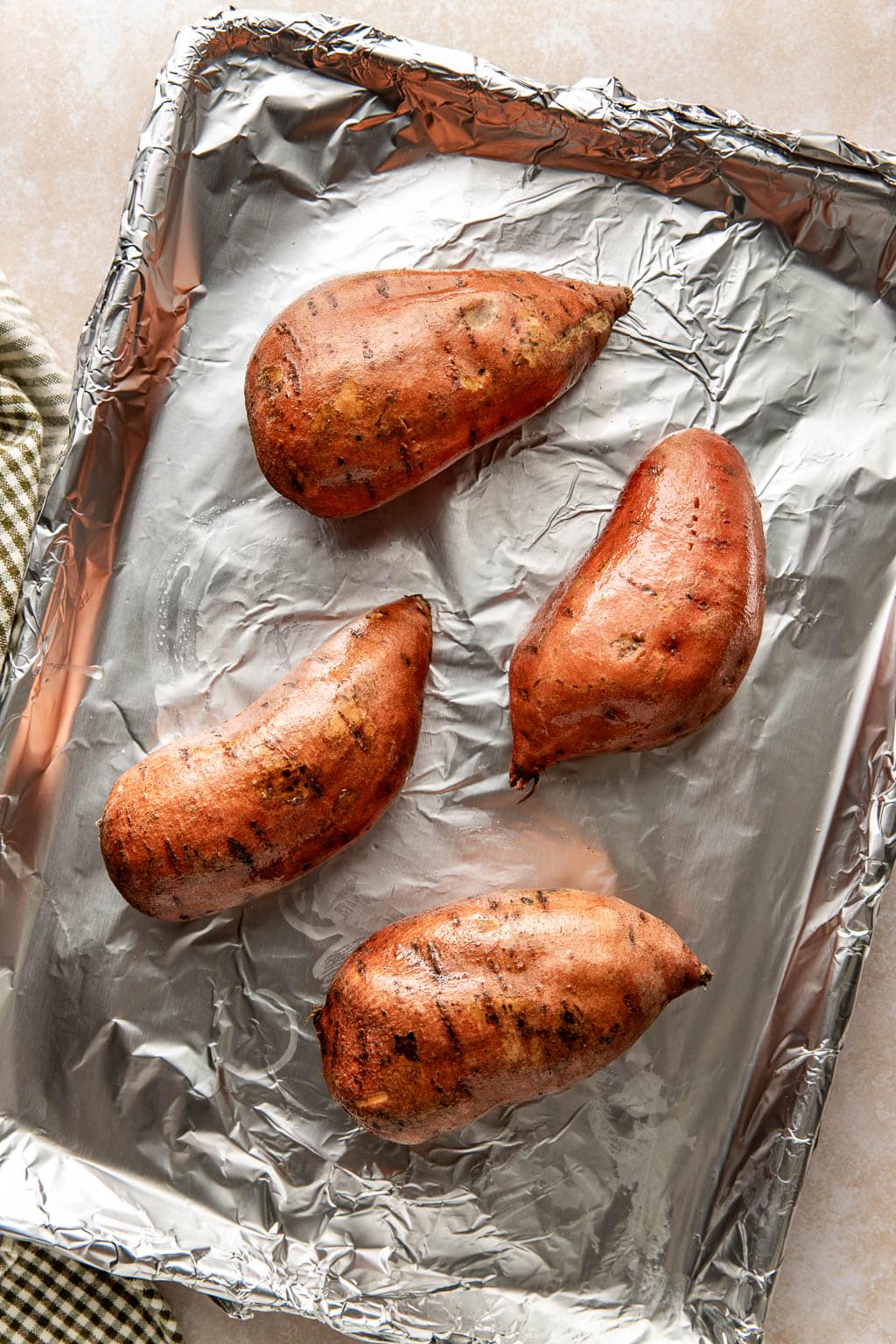 Sweet potatoes on baking sheet. 