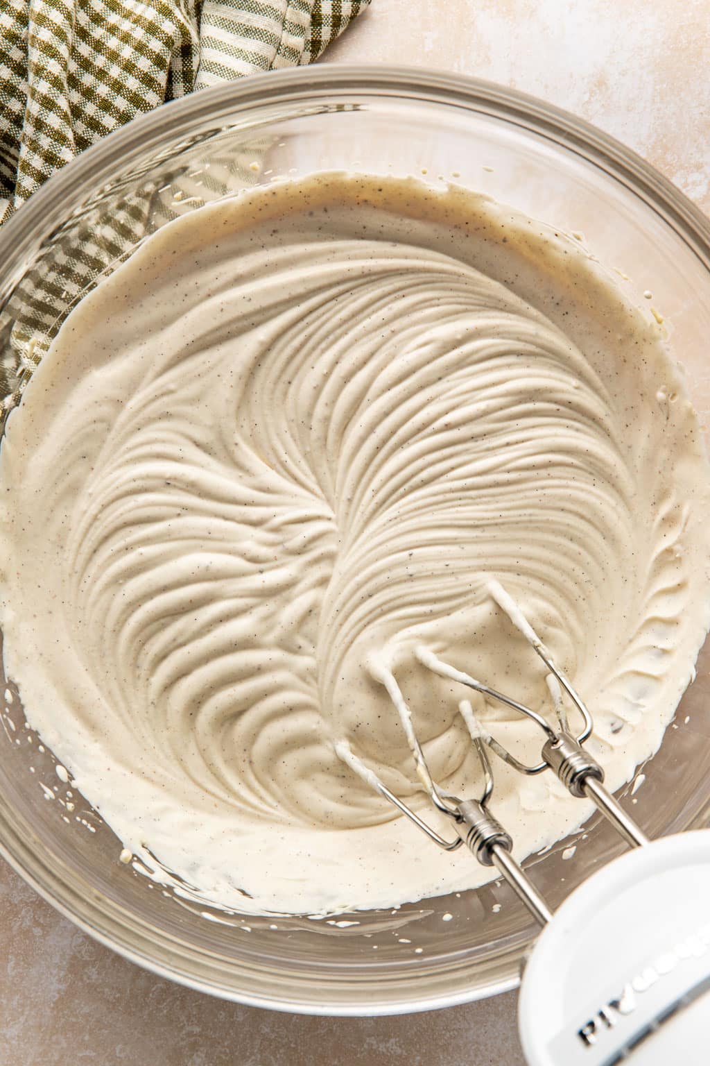 Cream cheese stabilized whipped cream in a mixing bowl. 
