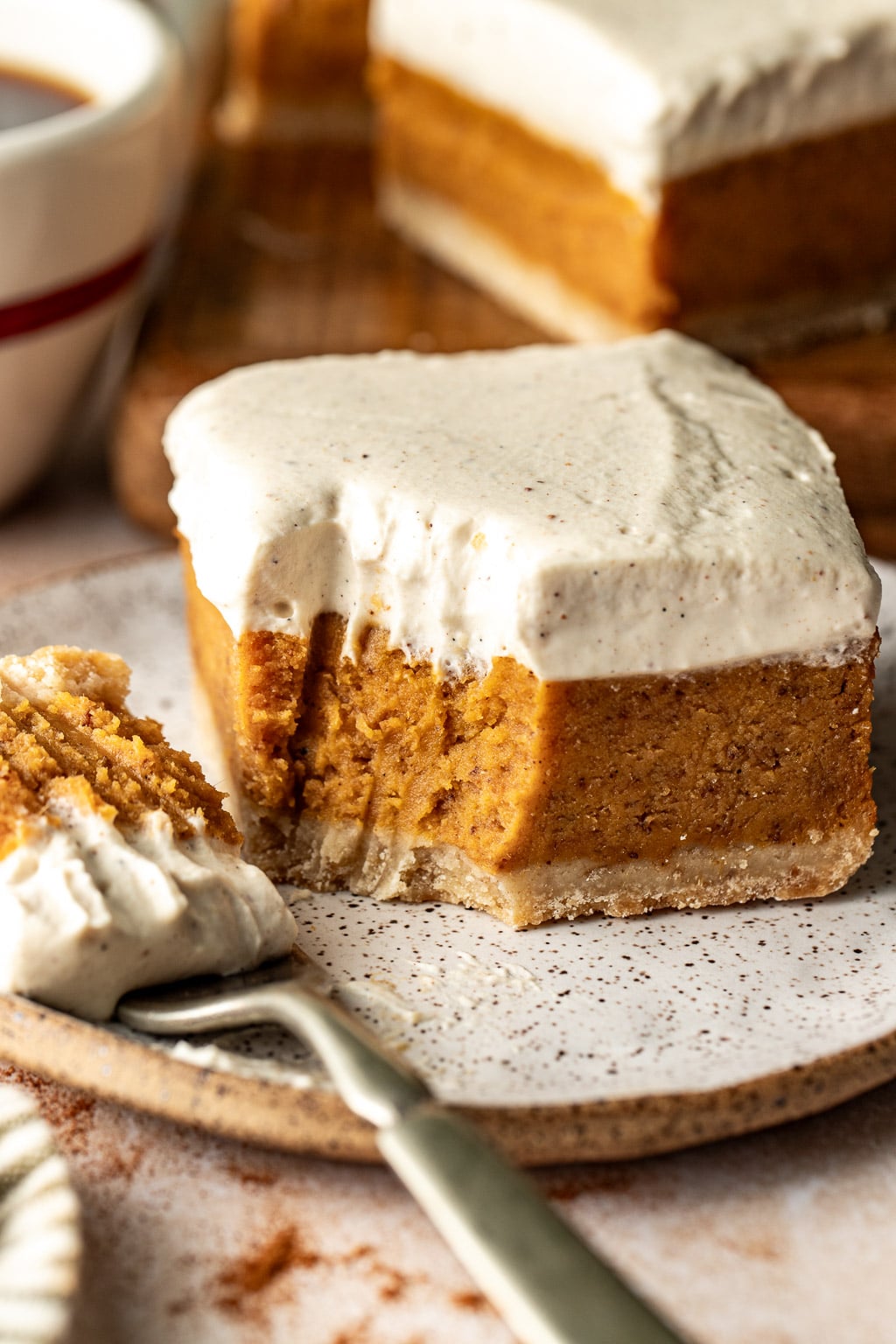 A sweet potato pie bar with a bite missing. 