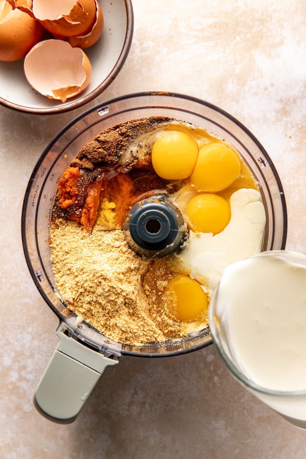 pumpkin pie filling ingredients in the bowl of a food processor