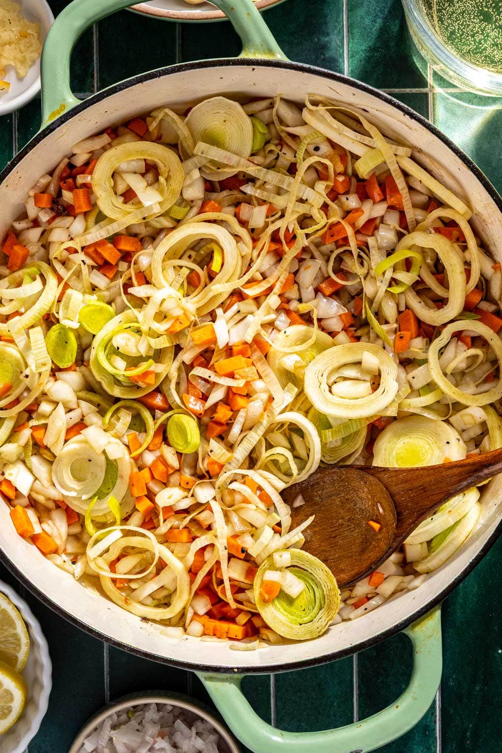 Leeks, onions, and carrots being sautéed