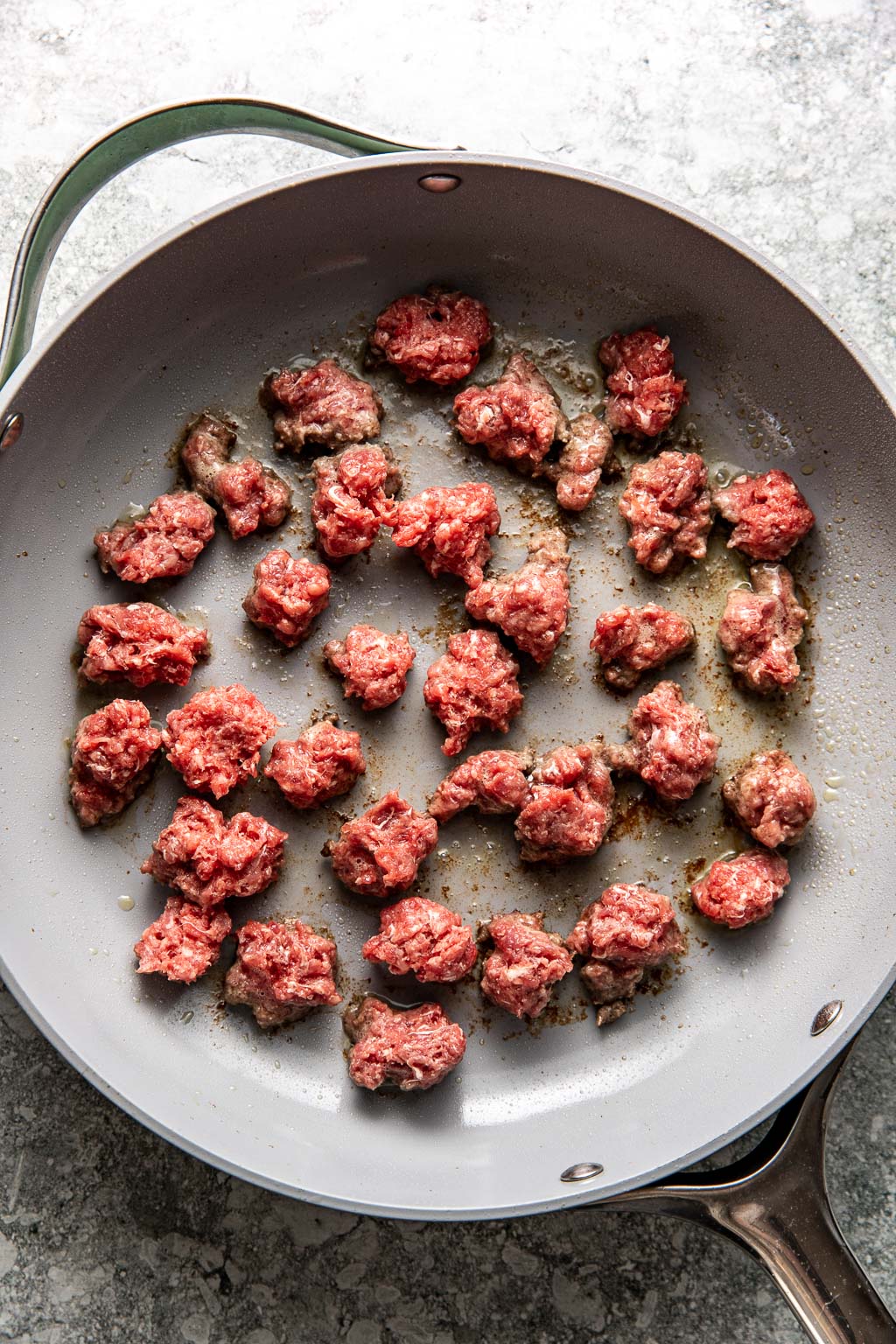 Pieces of beef browning in a skillet