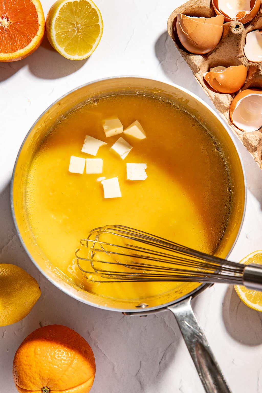butter being added to the citrus curd