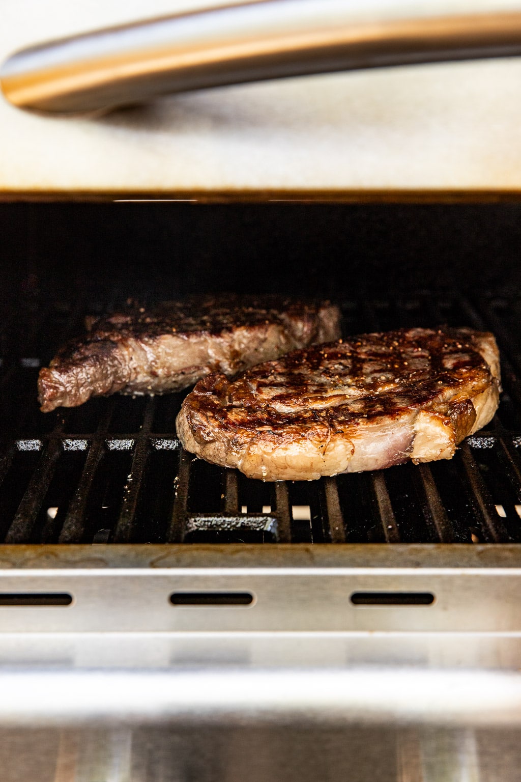 ribeye steaks on the grill