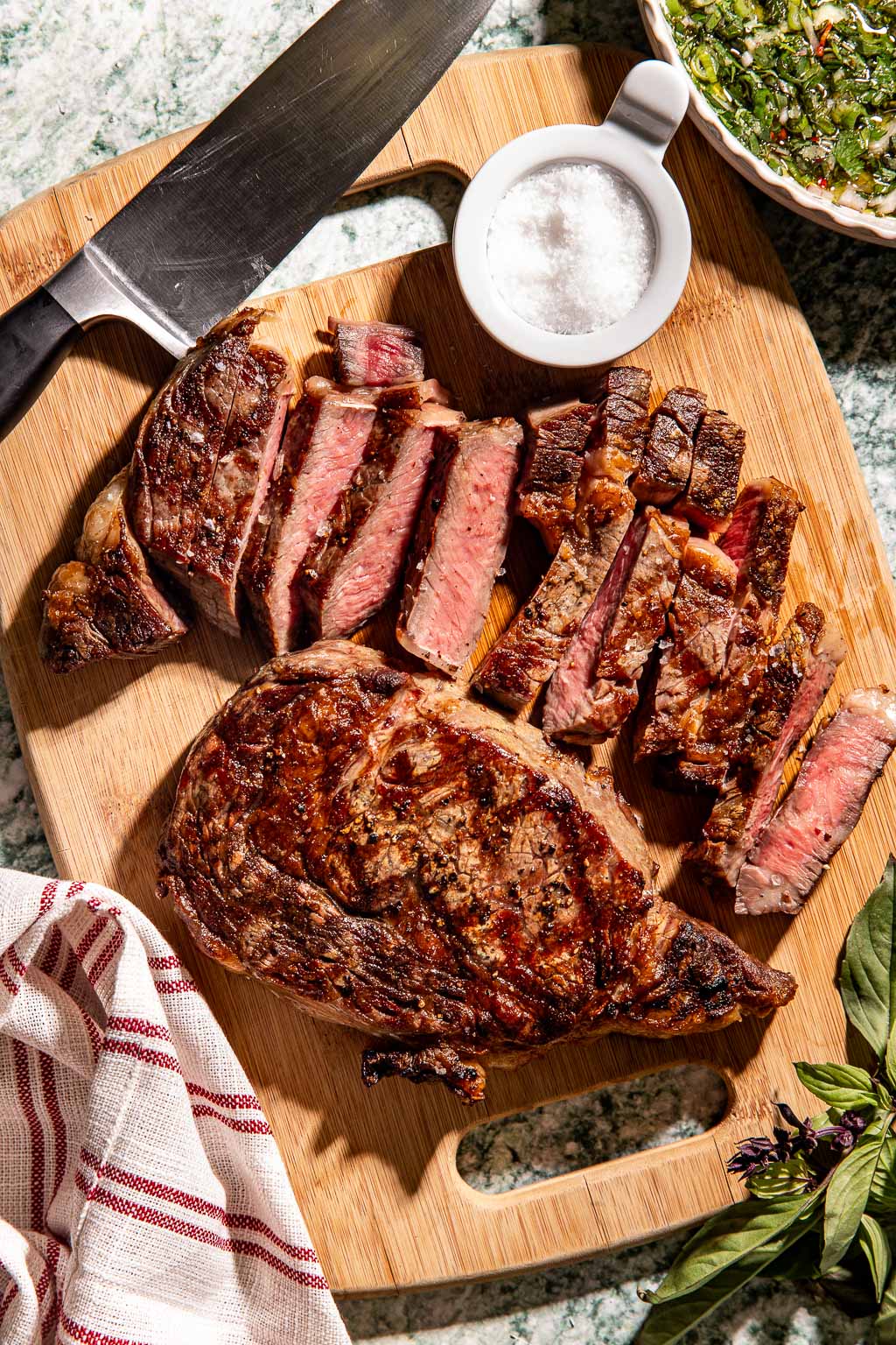 sliced steak on a cutting board after resting