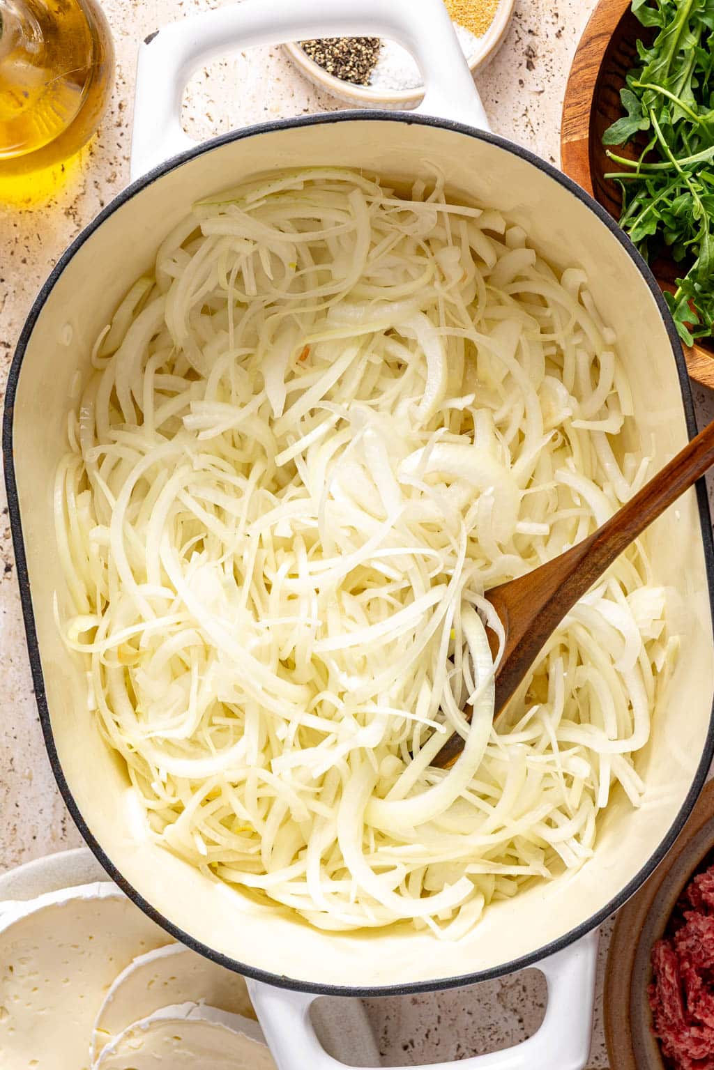 thinly sliced onions in a dutch oven before caramelizing