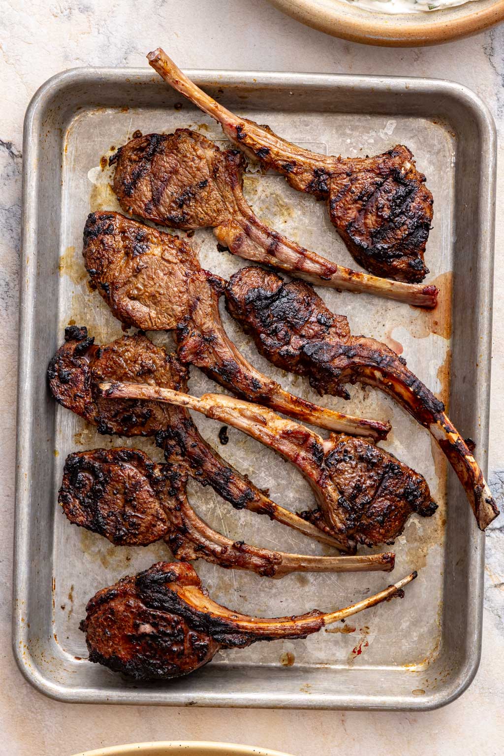 spiced lamb chops on a baking sheet after grilling