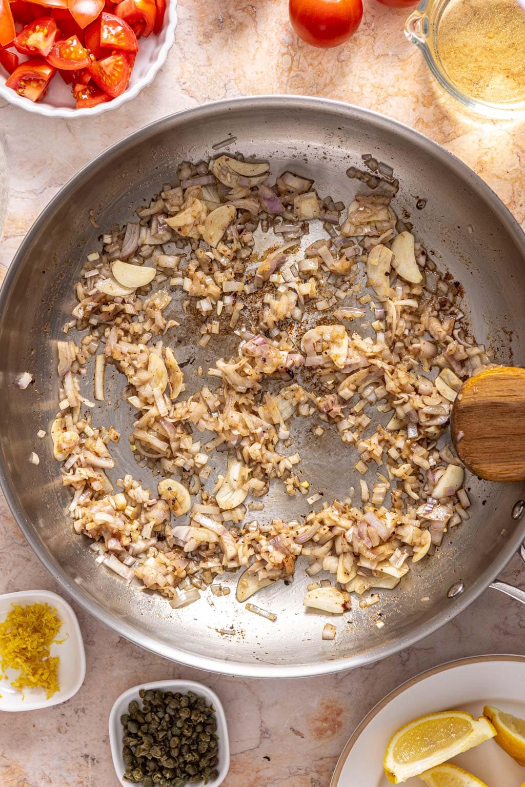 shallots and garlic sautéing in a skillet