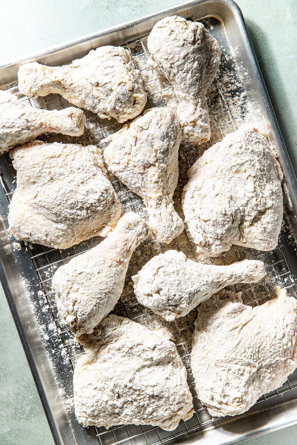 dredged chicken on a wire rack before frying