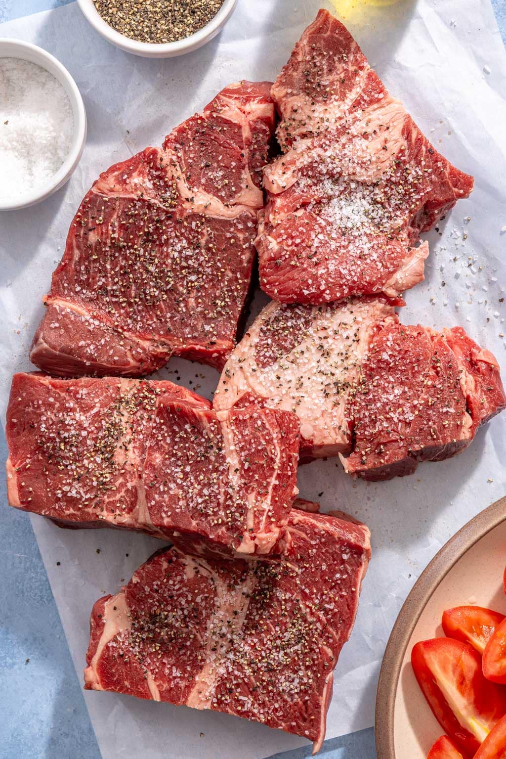 Seasoned beef chuck pieces on a cutting board