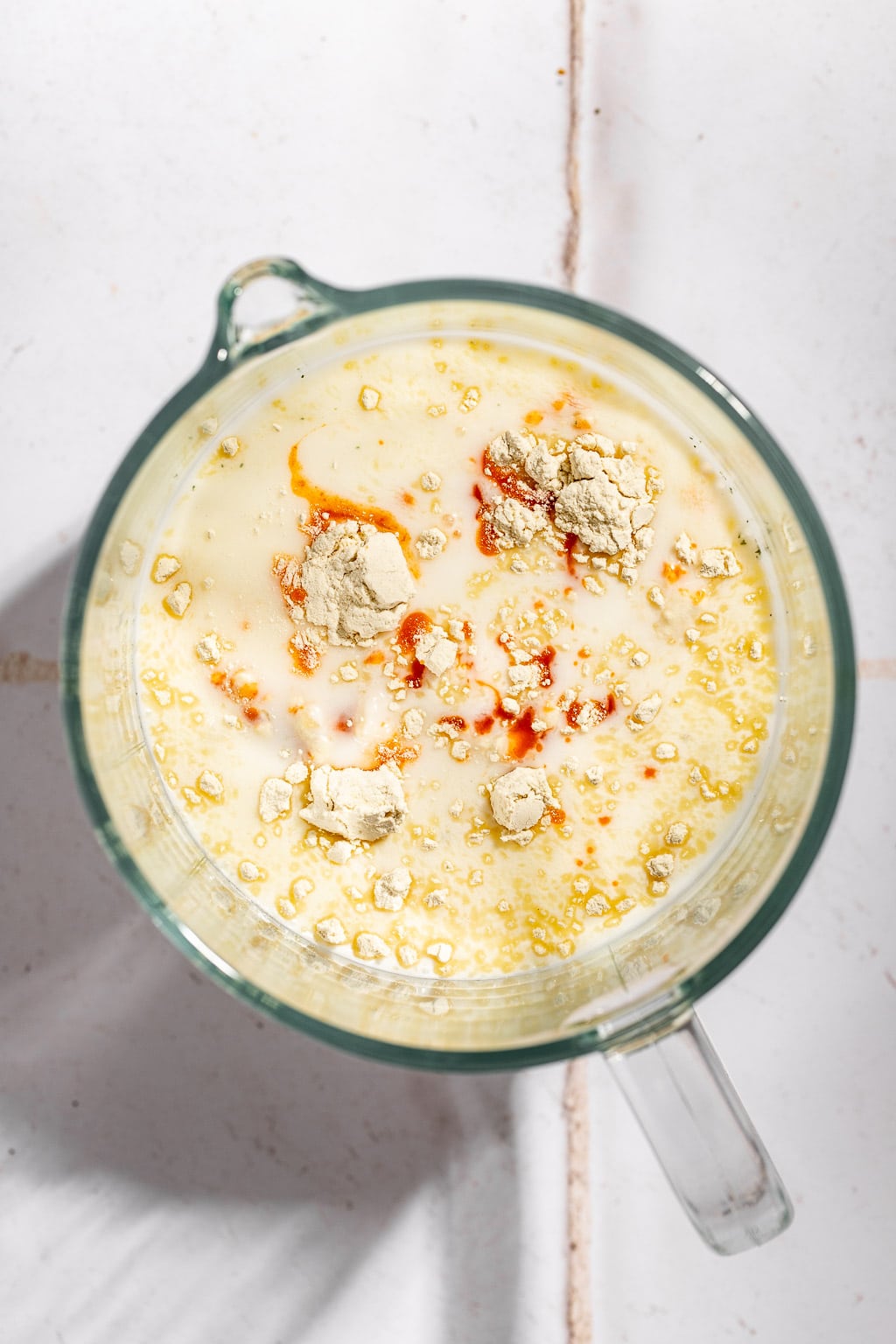 pickle juice and buttermilk brine in a large measuring cup