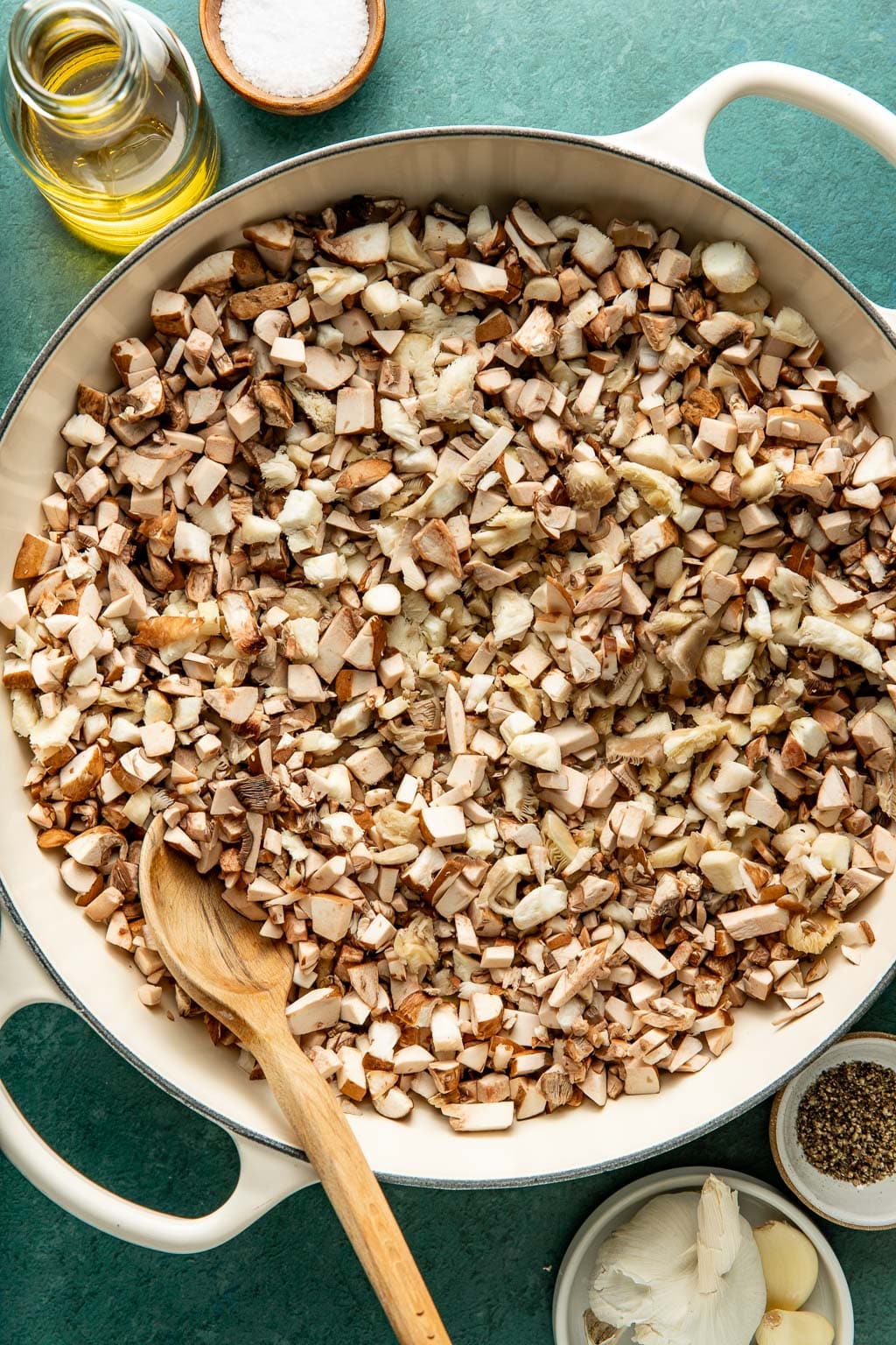 sauteeing chopped mushrooms in a braiser