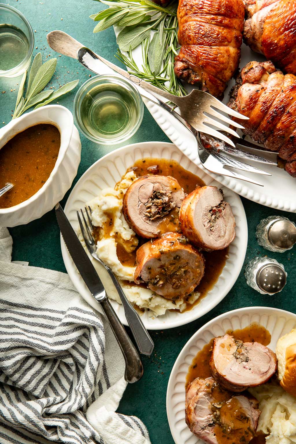 mushroom stuffed turkey roulade on a bed of mashed potatoes